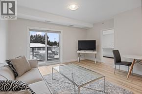 Kingsville condo for rent - A living room with a couch, chair, and television.