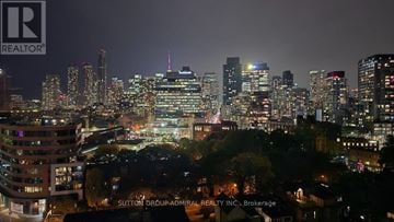 Toronto (Moss Park) condo for rent - A cityscape at night with the Sutton Group-Admiral Realty Inc. logo in the bottom right corner.