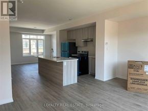 Clarington (Bowmanville) townhouse for rent - A kitchen area with a dishwasher and a box of dishwasher tablets.