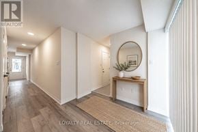 Clarington (Bowmanville) townhouse for rent - A kitchen area with a blue fridge and a dishwasher with a box of Dishwasher Detergent on the floor.
