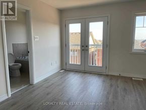 Clarington (Bowmanville) townhouse for rent - A room with a toilet and a window with a view of a building.