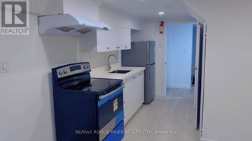 Toronto (Wexford-Maryvale) apartment for rent - A brokerage kitchen with a blue stove and white cabinets.