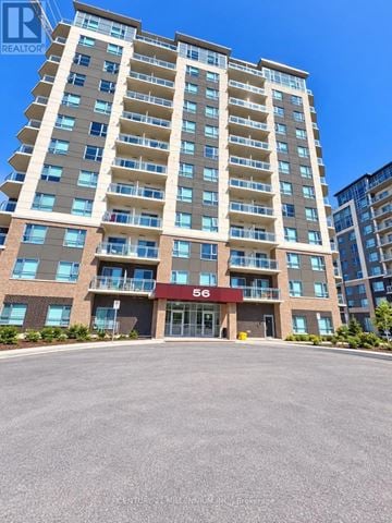 Barrie (Little Lake) condo for rent - A tall residential building with the number 56 on the front.