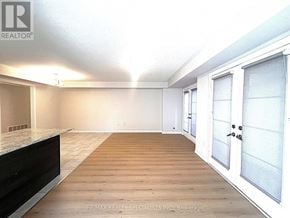 Brampton (Northwest Brampton) townhouse for rent - A room with a wooden floor and white walls.