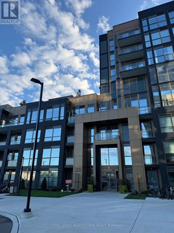 Oakville (Wm Westmount) condo for rent - A modern multi-story building with a glass facade and a large entrance.