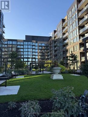 Oakville (Wm Westmount) condo for rent - A large building with a lot of windows and a garden in front.