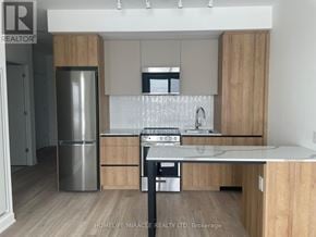 Brampton (Northwest Brampton) condo for rent - A kitchen with wooden cabinets and a stainless steel refrigerator.