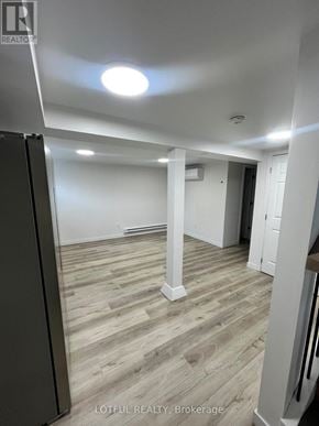 Ottawa apartment for rent - A room with wooden flooring and white walls.