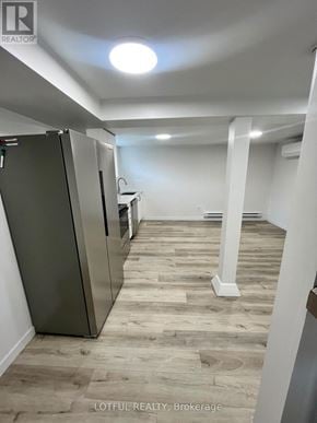 Ottawa apartment for rent - A spacious room with a refrigerator and a countertop.