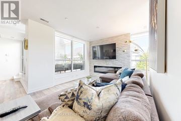 Innisfil townhouse for rent - A living room with a brown couch and a fireplace.
