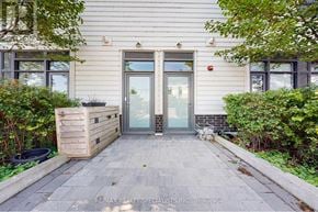Innisfil townhouse for rent - The image shows a house entrance with a glass door and a wooden planter box to the left.