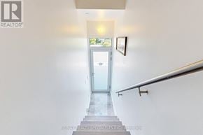 Innisfil townhouse for rent - A hallway with a glass door at the end and a picture on the wall.