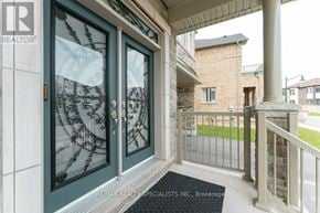 Hamilton (Waterdown) apartment for rent - A house entrance with a glass door and a brokerage sign.