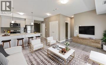 Windsor condo for rent - A living room with a white couch and a coffee table in the center.