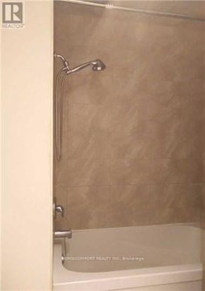 Toronto (Westminster-Branson) apartment for rent - A white bathtub with a shower head attached to the wall.