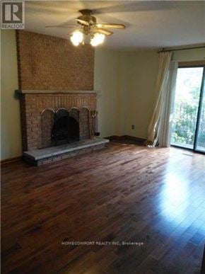 Toronto (Westminster-Branson) apartment for rent - A living room with a fireplace and wood floors.