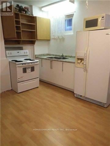 Toronto (Westminster-Branson) apartment for rent - A kitchen with a white refrigerator, white stove, and white cabinets.