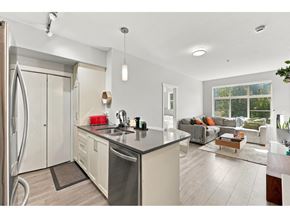 Surrey apartment for rent - A modern kitchen with a large island and a refrigerator with a water dispenser.