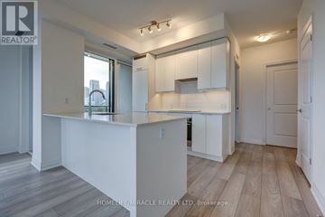 Mississauga (Fairview) condo for rent - A well-lit kitchen with white cabinets and a wooden floor.