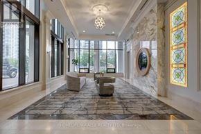 Mississauga (Fairview) condo for rent - A hallway with a rug, chairs, and a stained glass window.
