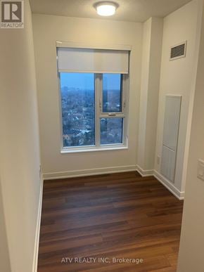 Toronto (Islington-City Centre West) condo for rent - A room with a window overlooking a cityscape.