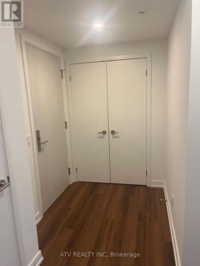 Toronto (Islington-City Centre West) condo for rent - A hallway with white doors and wood floors.