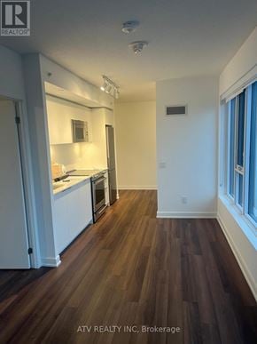 Toronto (Islington-City Centre West) condo for rent - A kitchen with white cabinets and a wooden floor.