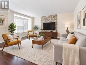 London South (South W) townhouse for rent - A living room with a stone fireplace and a grey couch.