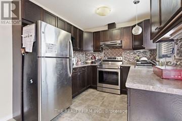 London South (South W) townhouse for rent - A kitchen with a refrigerator and a stove top oven.