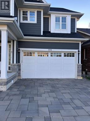 Hamilton (Meadowlands) apartment for rent - A house with a white garage door and a black roof.