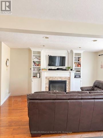 London South (South V) apartment for rent - A living room with a brown leather couch and a fireplace.