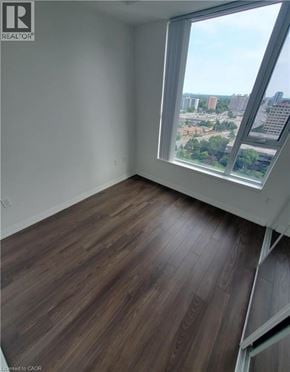 Toronto condo for rent - A room with a large window overlooking a cityscape.