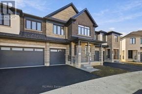 Hamilton (Waterdown) townhouse for rent - A row of new houses with garages in front.
