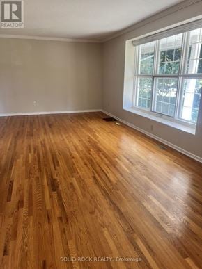Ottawa apartment for rent - A room with wooden flooring and a window.