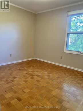 Ottawa apartment for rent - A room with wooden flooring and a window.
