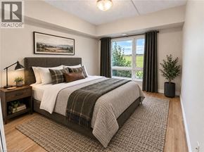 Guelph condo for rent - A bedroom with a large bed and a window with curtains.