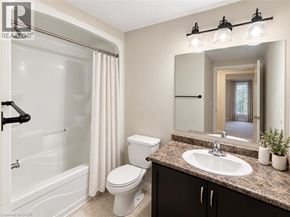 Guelph condo for rent - A bathroom with a white toilet and sink.