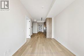 Toronto (Mount Pleasant West) condo for rent - A long hallway with wood floors and white walls.