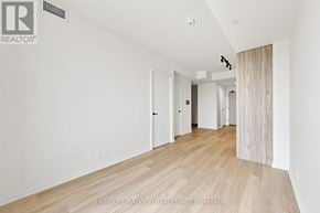 Toronto (Mount Pleasant West) condo for rent - A long hallway with wood floors and white walls.