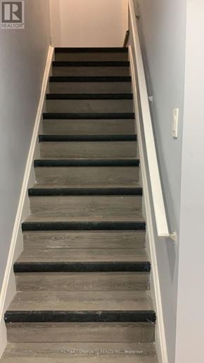 Oshawa (Windfields) apartment for rent - A staircase with wooden steps and white handrails.