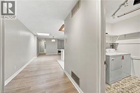 Hamilton apartment for rent - A long hallway with a Realtor sign on the wall.