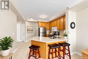 Bradford West Gwillimbury (Bradford) condo for rent - A kitchen with wooden cabinets and a white countertop.