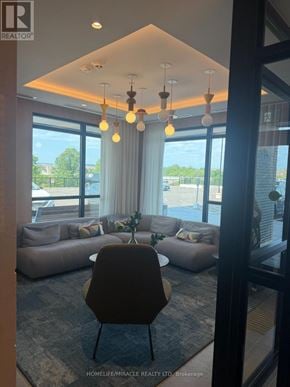 Milton (Cb Cobban) condo for rent - A living room with a large window and a view of the outside.