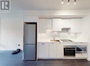 Toronto (Mount Pleasant West) condo for rent - A modern kitchen with white cabinets and stainless steel appliances.