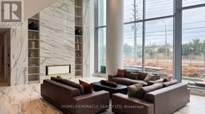 Mississauga (City Centre) condo for rent - A living room with a marble wall and a large window.