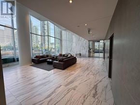 Mississauga (City Centre) condo for rent - A spacious lobby with marble flooring and large windows.