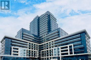 Oakville (Jm Joshua Meadows) condo for rent - A modern multi-story building with a glass facade.