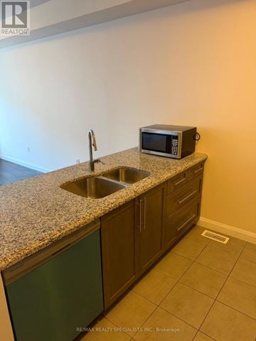 Hamilton (Ancaster) townhouse for rent - A kitchen counter with a sink and a microwave on it.