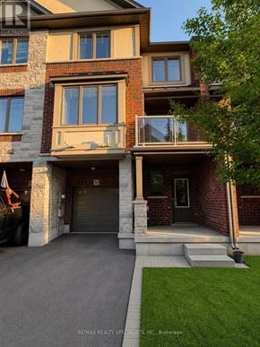 Hamilton (Ancaster) townhouse for rent - A large house with a garage and a balcony.