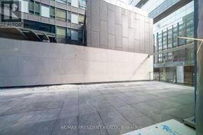 Toronto (Moss Park) condo for rent - A large, empty, tiled room with a glass wall and a sign that says RE/MAX PRESIDENT REALTY, Brokerage.